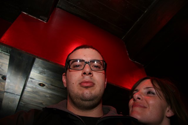 Low-Angle Nightclub Portrait Under Red Lighting
