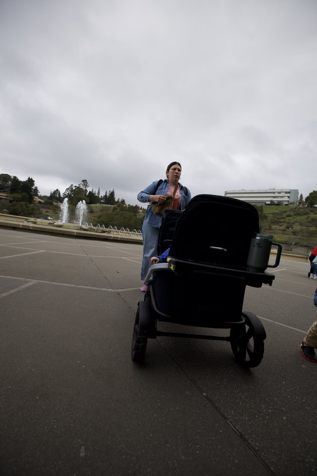 Woman with Baby Stroller in Cloudy Park Plaza