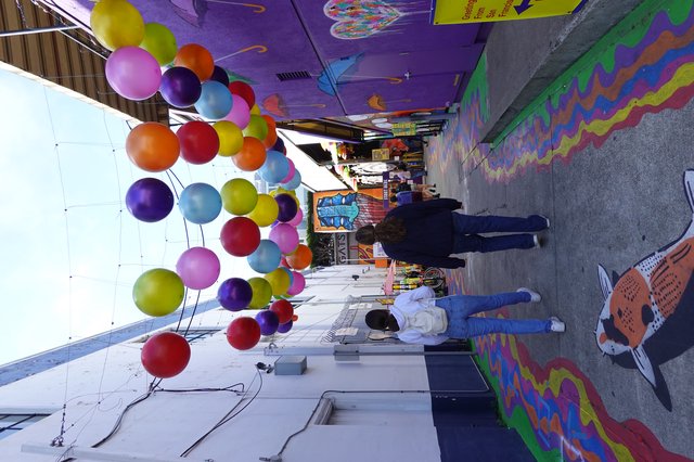 Colorful Balloon Installation in Vibrant Street Alley