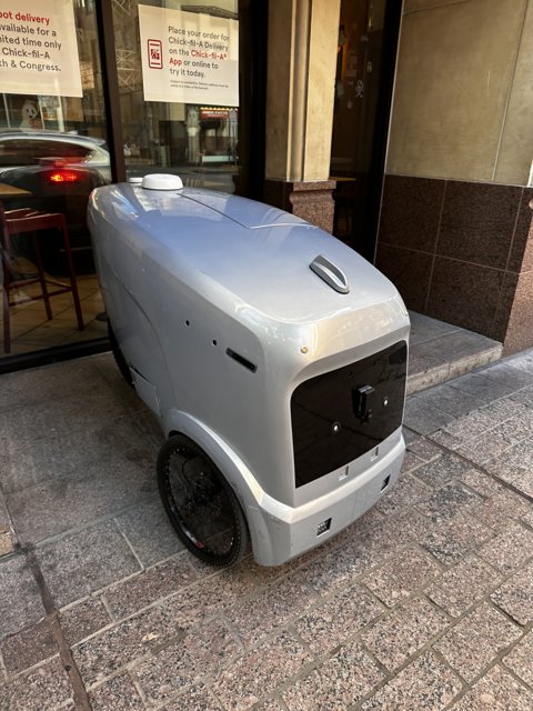 Small Silver Vehicle Parked on Austin Sidewalk