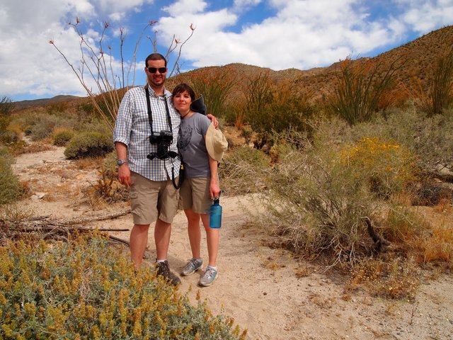 Couple Posing on Desert Trail Among Spring Blooms