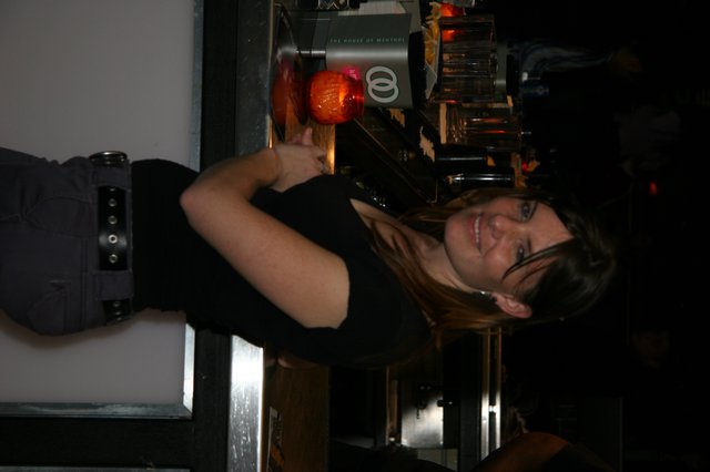 Woman Smiling at Bar Counter in Nightclub