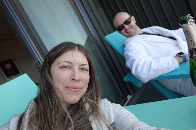 Couple Relaxing on Turquoise Pool Lounge Chairs
