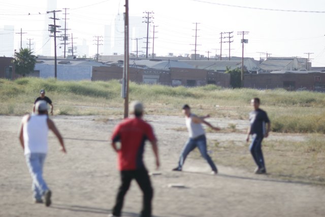 Group Baseball Game in Dirt Field