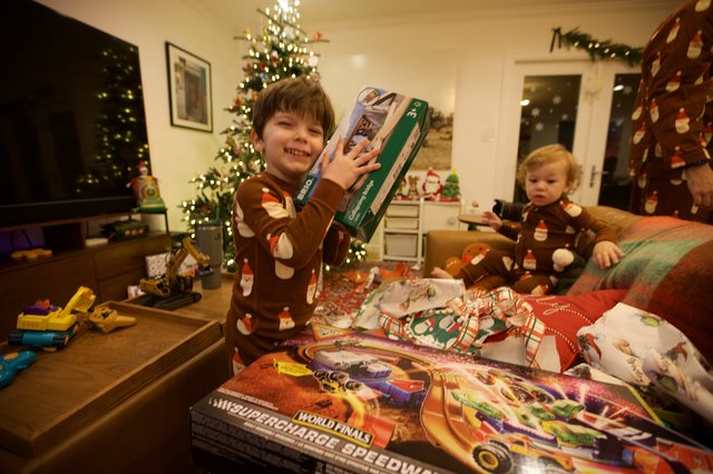Excited Boy with Christmas Presents on Holiday Morning