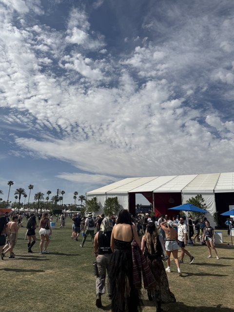 Vibrant Crowd Under Cloudy Skies