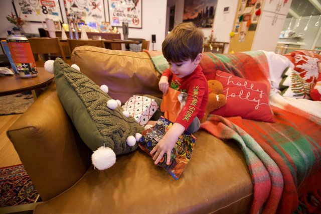 Christmas Morning Joy: Child Opening Holiday Gifts