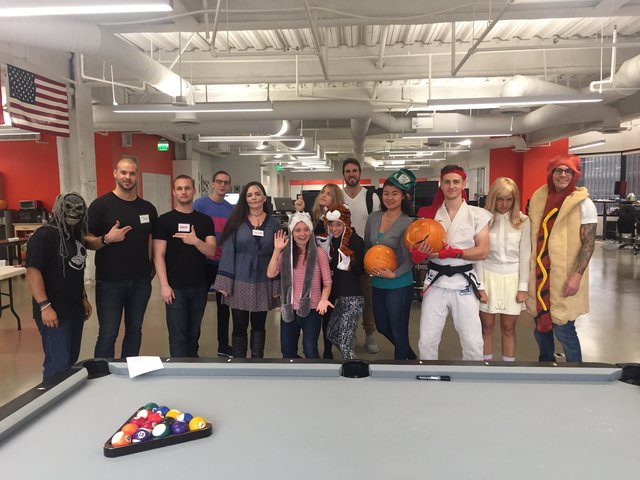 Office Halloween Costume Party Around Pool Table