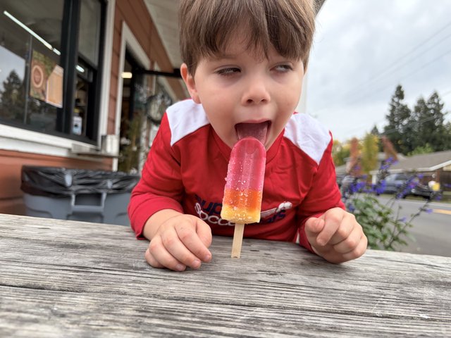 Pure Joy: Child Enjoying a Colorful Popsicle Outdoors
