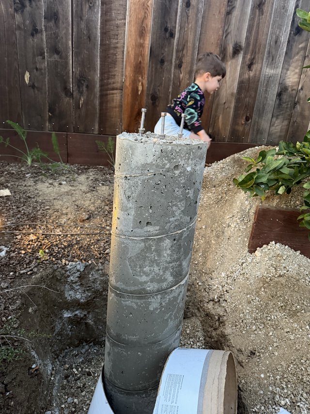 Concrete Pier Footing with Anchor Bolts in Backyard
