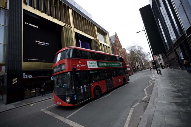 Red Double-Decker Bus on Modern London Street