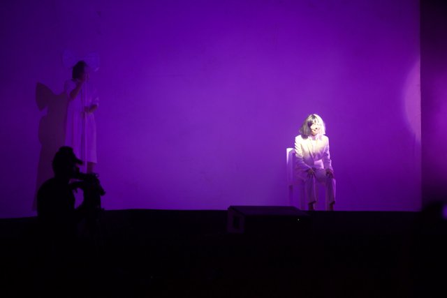 White-Clothed Woman Amidst Purple Lights