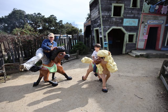 Children Riding Giant Toy Horses at Western Theme Park
