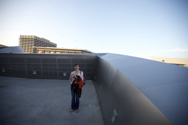 Woman Poses on Rooftop of Iconic Modern Museum