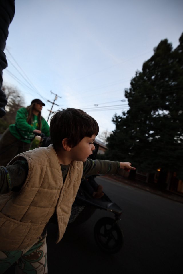 Child Points Forward on Evening Street Walk
