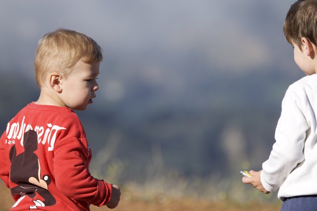 Two Young Boys in a Standoff Outdoors