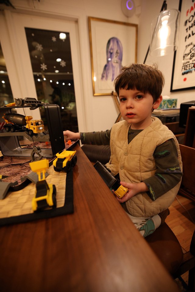 Young Boy Playing with Construction Toy Set at Home