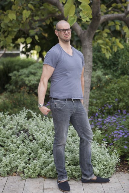 Man in Jeans Standing in Foliage