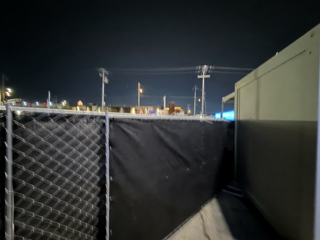 Chain Link Fence with Privacy Screen at Night