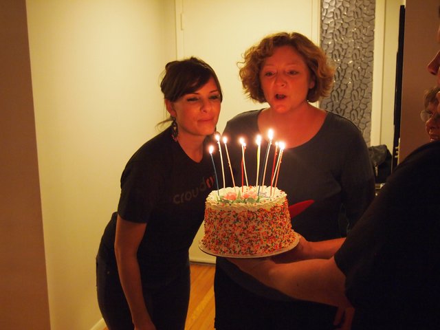 Birthday Wishes: Two Women Blowing Out Candles Together