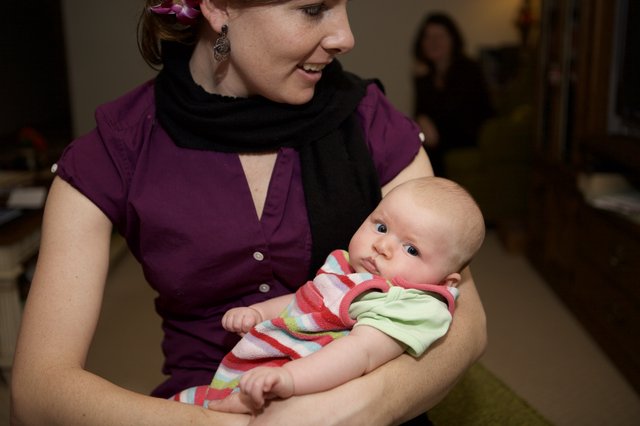 Mother's Smile: Tender Moment with Newborn Baby