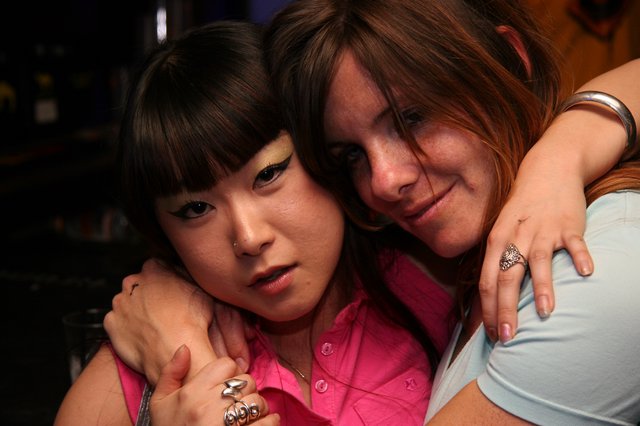 Two Friends Share a Close Embrace at Night