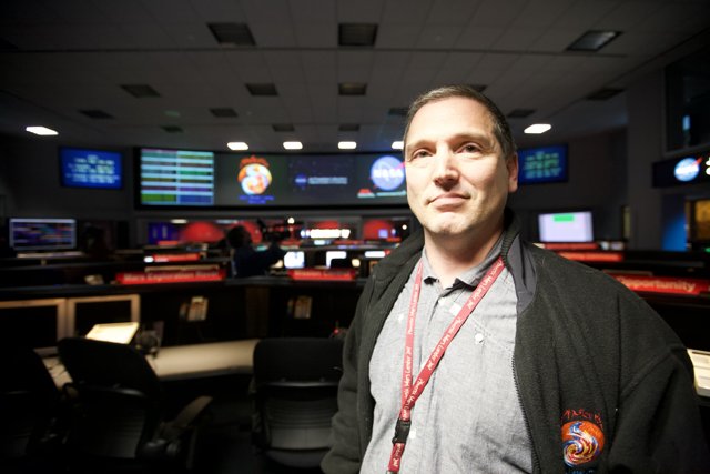 Man with 5 Monitor Setup for Mars Lander Mission