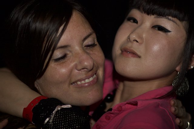 Two Friends Share a Warm Embrace at Night