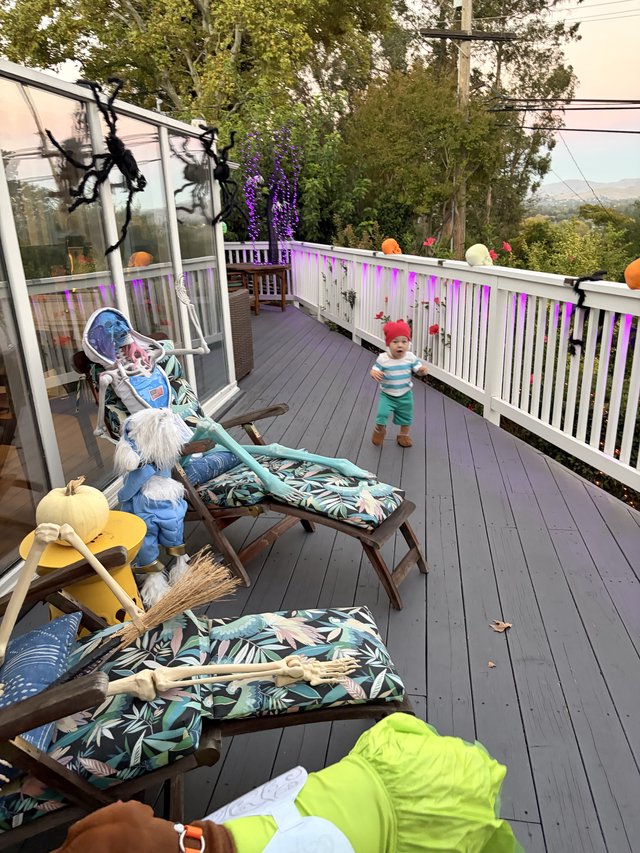 Halloween Decorated Deck with Toddler in Foggy Setting