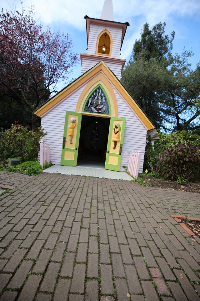 Whimsical Chapel Entrance with Colorful Doors and Steeple