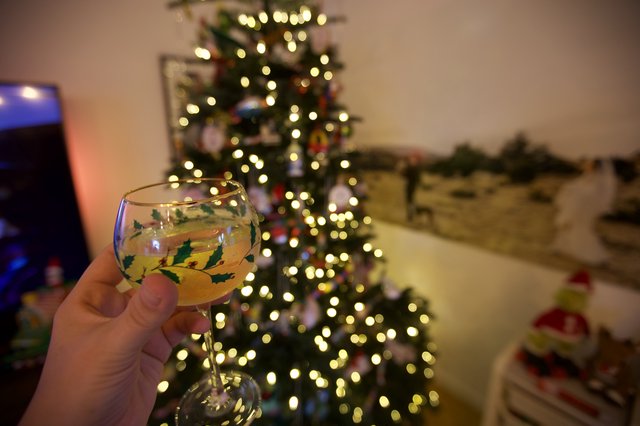 Christmas Toast with Festive Wine Glass and Tree