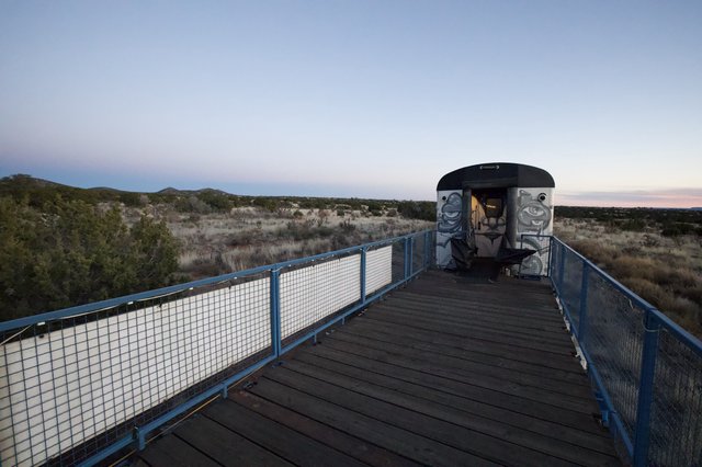 Abandoned Train Car on Desert Observation Deck at Twilight