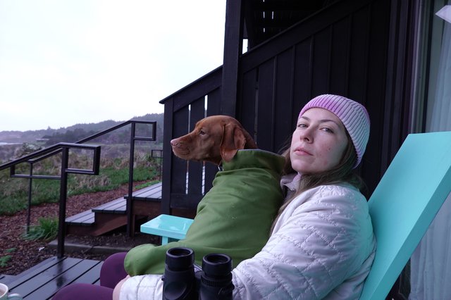 Woman and Dog Relaxing on Outdoor Deck
