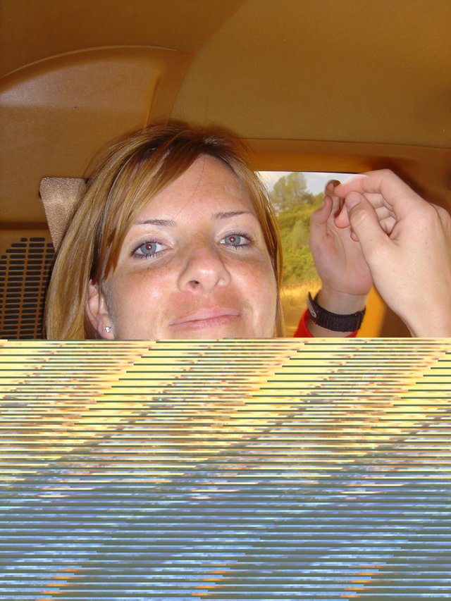Penelope's Playful Glance in a Yellow Car Interior