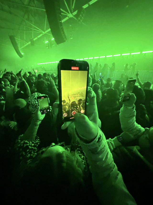 Recording a Concert Through Phone Screen in Green Light
