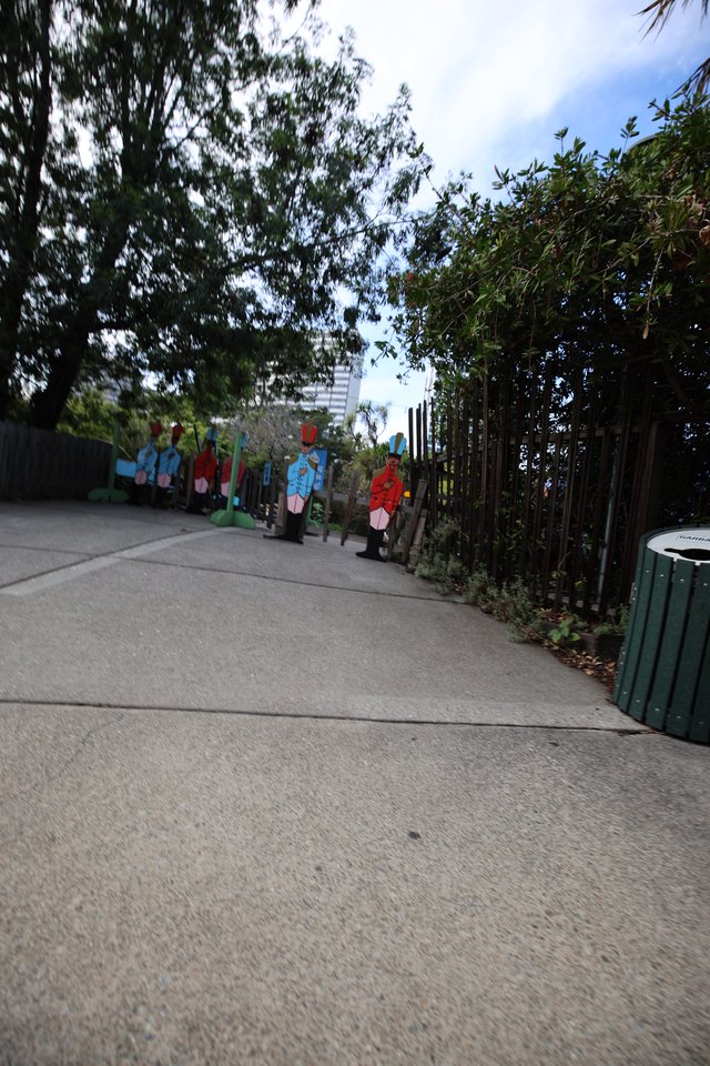 Colorful Character Cutouts Along Garden Pathway