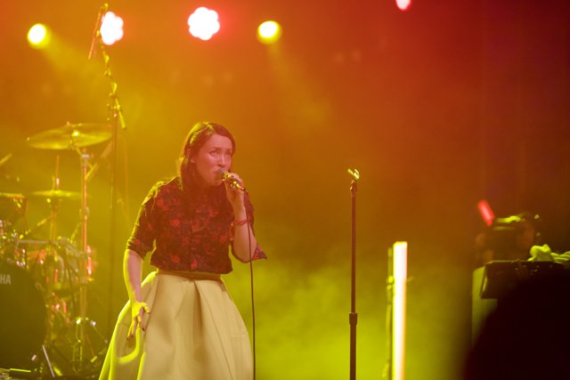 Spotlight on Yukimi Nagano Caption: Yukimi Nagano rocks the stage at Coachella 2014, performing her hit songs in style with her signature skirt and powerful vocals. The crowd is entranced by her performance, while Yukimi shines in the spotlight with her microphone in hand.
