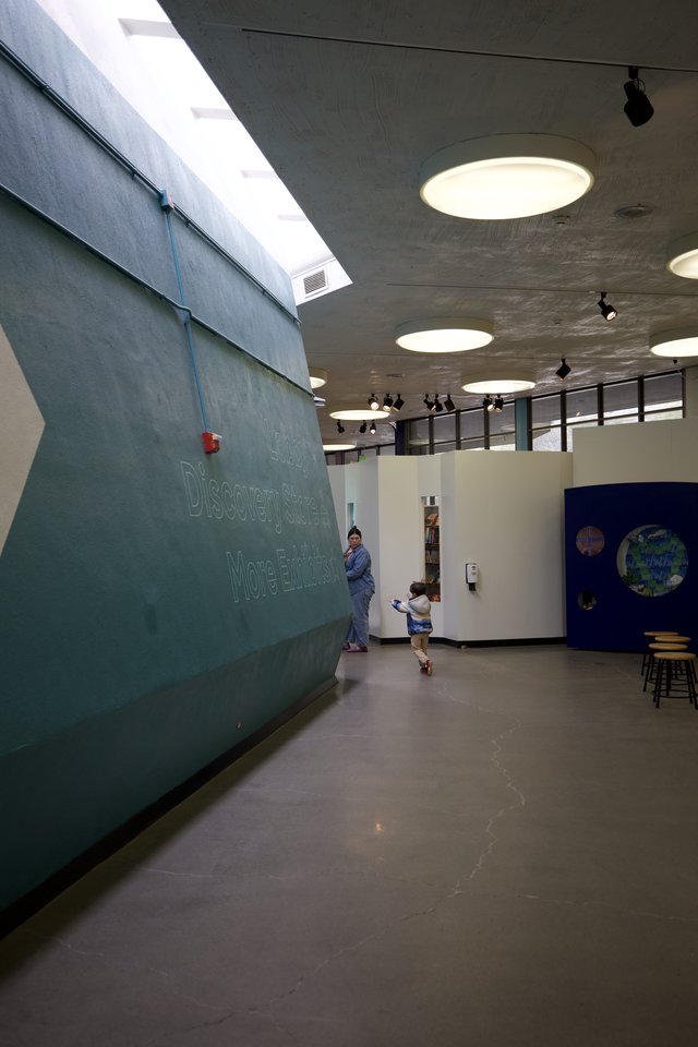 Child Running Through Modern School Hallway with Skylights