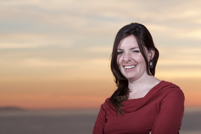 Joyful Woman Laughing at Sunset by the Sea