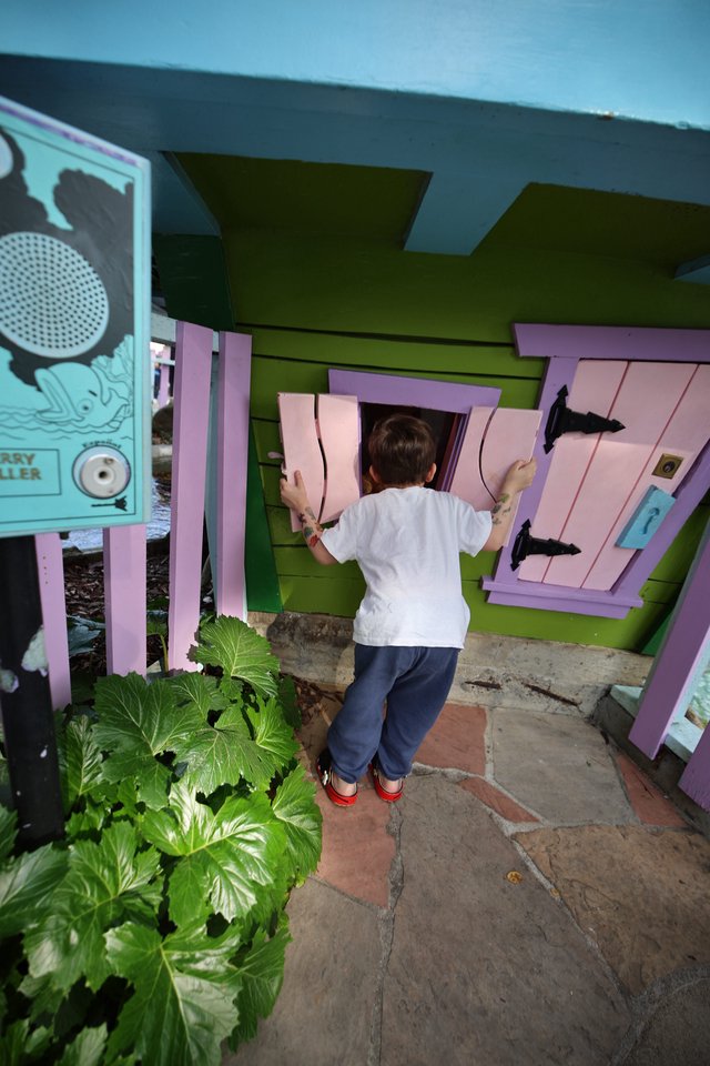 Child Playing at Colorful Miniature Playhouse