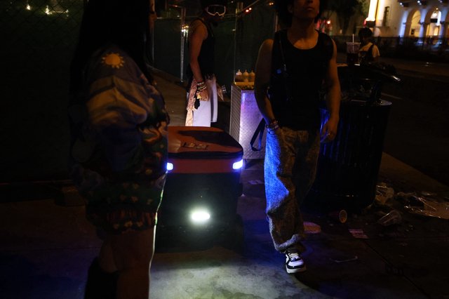 Delivery Robot Navigates Night Festival Crowd