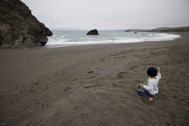 Solitary Child Playing on Dramatic Pacific Coastline