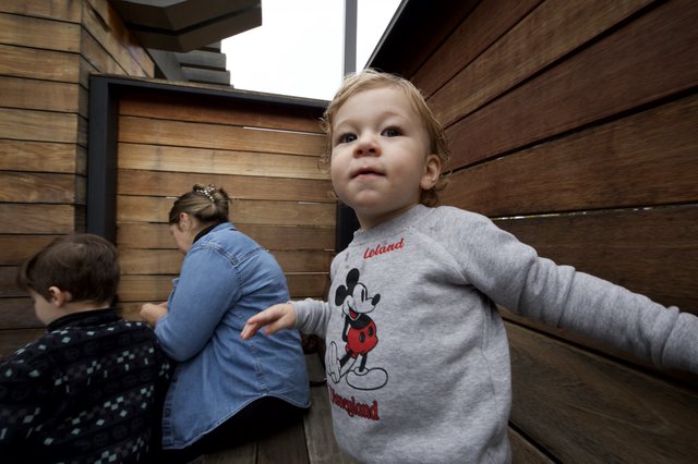 Toddler in Mickey Mouse Sweatshirt Exploring Indoor Space