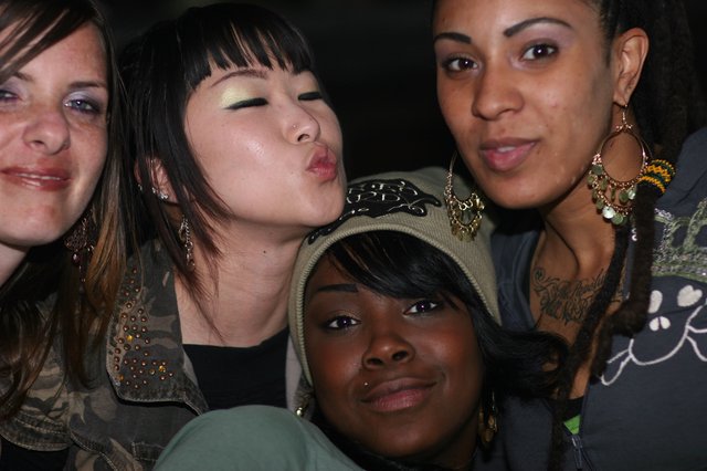 Four Friends Posing Together at a Nightlife Event