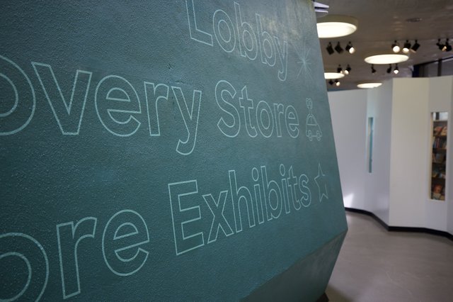 Contemporary Museum Lobby with Textured Teal Wall Typography