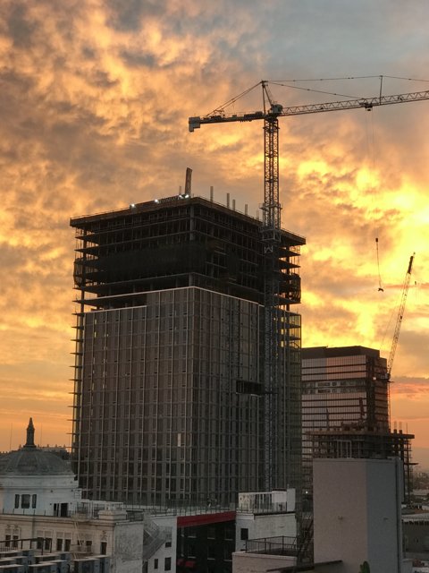 Towering Construction in the City at Sunset