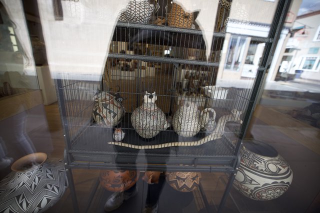 Decorated Pueblo Pottery Display Behind Wire Cage