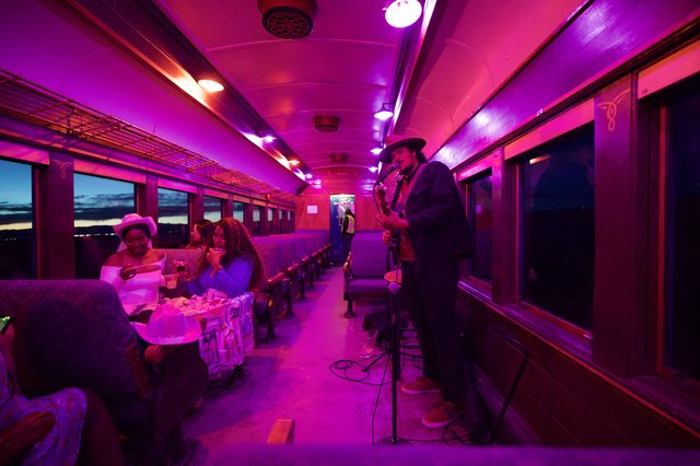 Purple-Lit Vintage Train Car Performance at Twilight