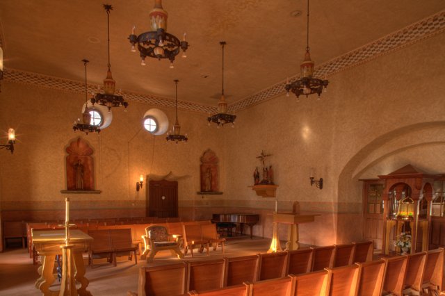 Church Interior with Elegant Chandeliers and Wooden Pews