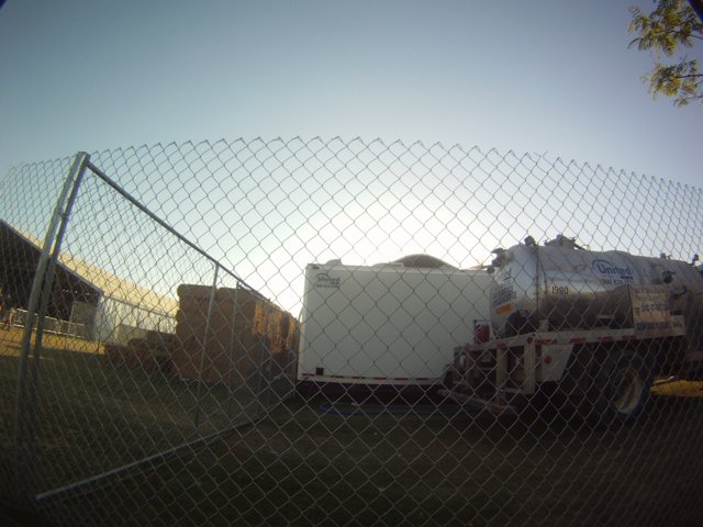 Parked Truck Behind Chain Link Fence
